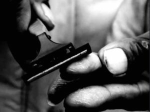 Fig. 7 (Sylvain George, 'Qu’Ils reposent en révolte', fingerpint mutilation by razor,00.41.26)